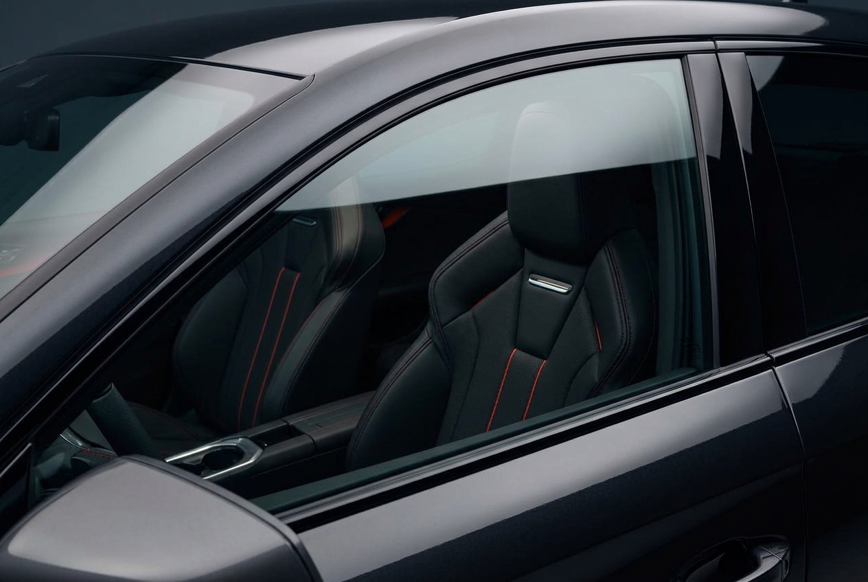 Close-up of a luxury vehicle side window with clear factory glass before tinting
